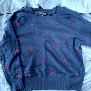 Navy blue crewneck sweater with accent hearts on front and back.